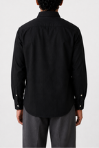 Cauzeway solid black Oxford cotton casual shirt in signature Indian regular fit, back view.