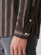 Close up of the tailored cuff and shadow stripe pattern on Cauzeway brown Oxford cotton shirt sleeve.