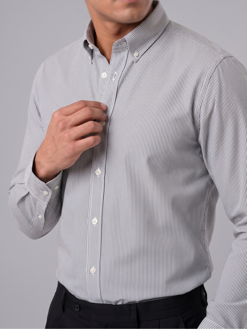 Model wearing Cauzeway charcoal grey pencil stripe shirt with button-down collar, close view.