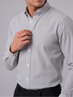 Model wearing Cauzeway charcoal grey pencil stripe shirt with button-down collar, close view.