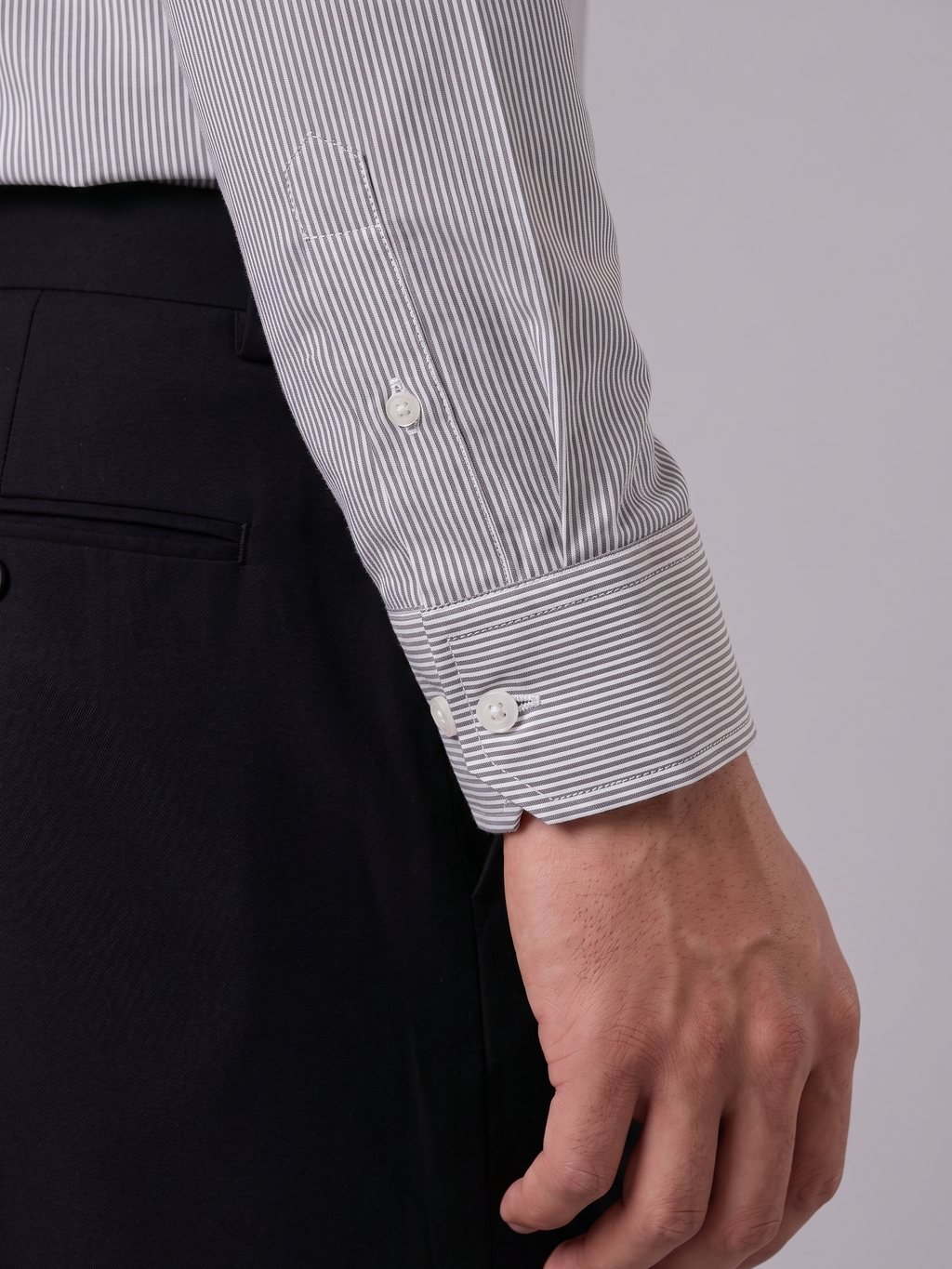 Close up of the tailored cuff and pencil stripe pattern on Cauzeway charcoal grey Cotton Tencel shirt.
