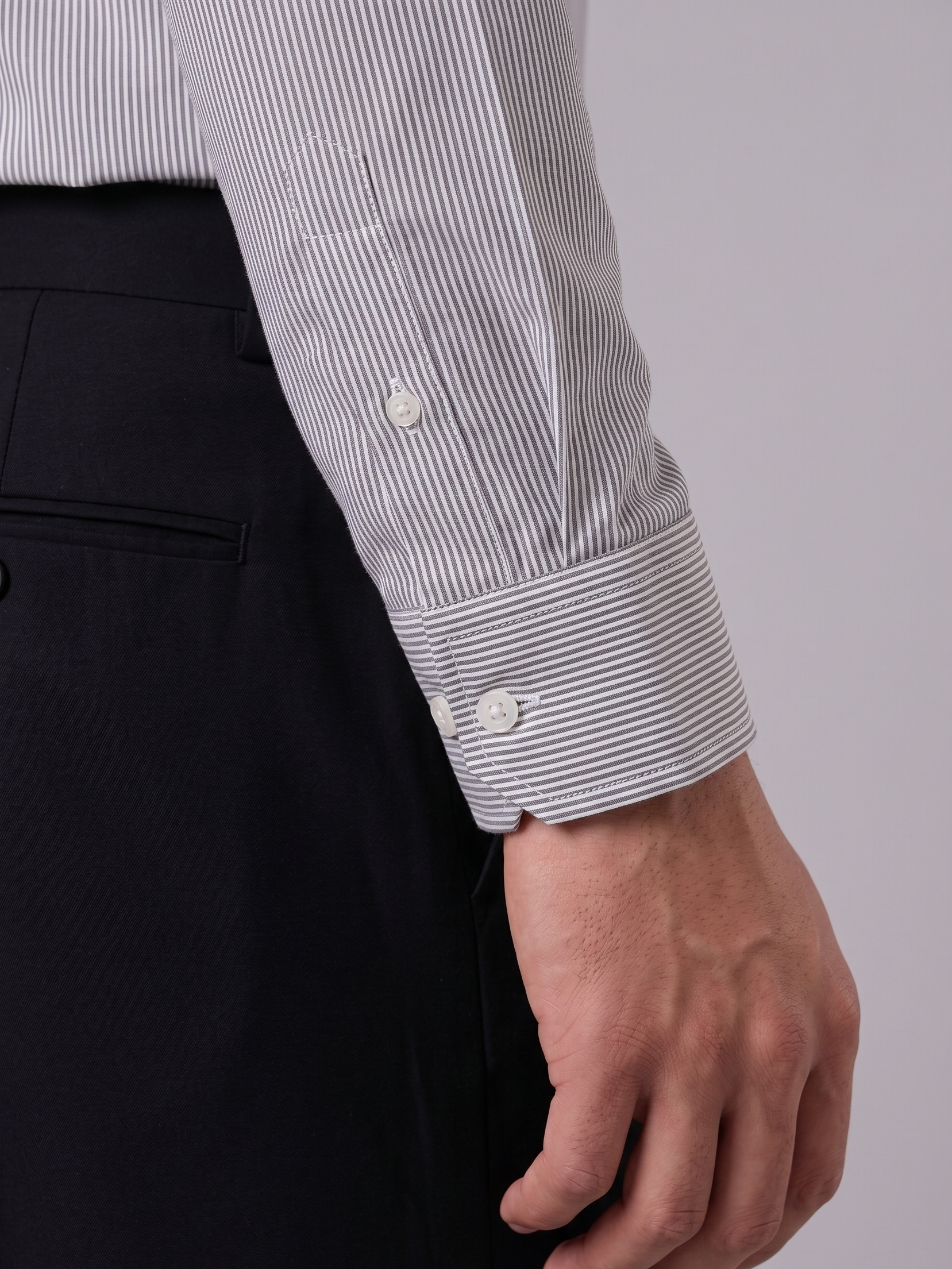Close up of the tailored cuff and pencil stripe pattern on Cauzeway charcoal grey Cotton Tencel shirt.