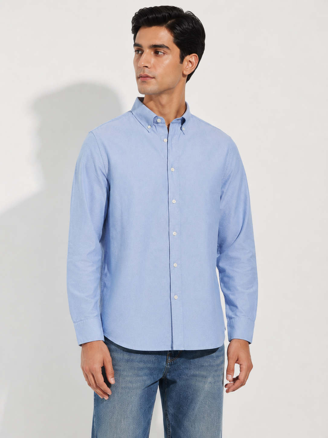 Model wearing Cauzeway chambray blue Oxford cotton casual shirt, three-quarter view