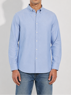 Model wearing Cauzeway chambray blue Oxford cotton casual shirt, three-quarter view