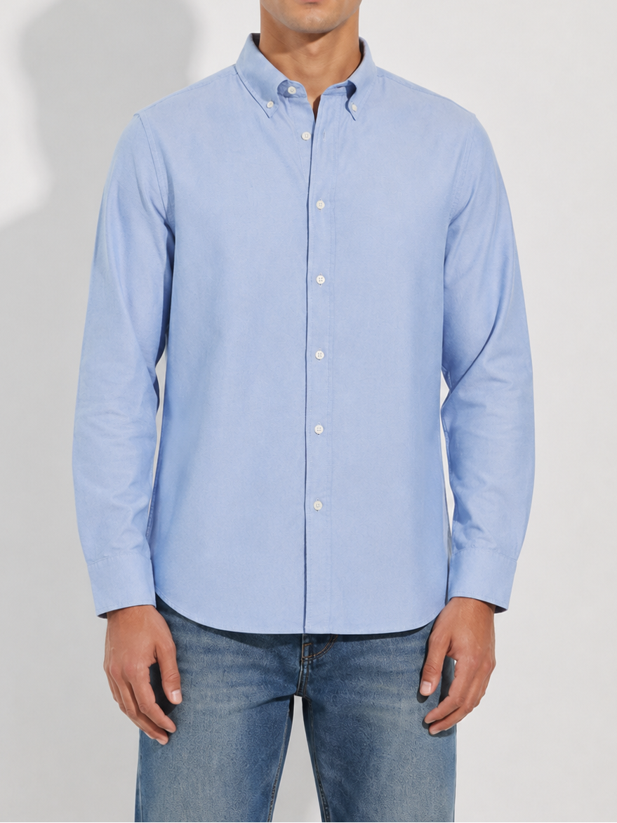 Model wearing Cauzeway chambray blue Oxford cotton casual shirt, three-quarter view
