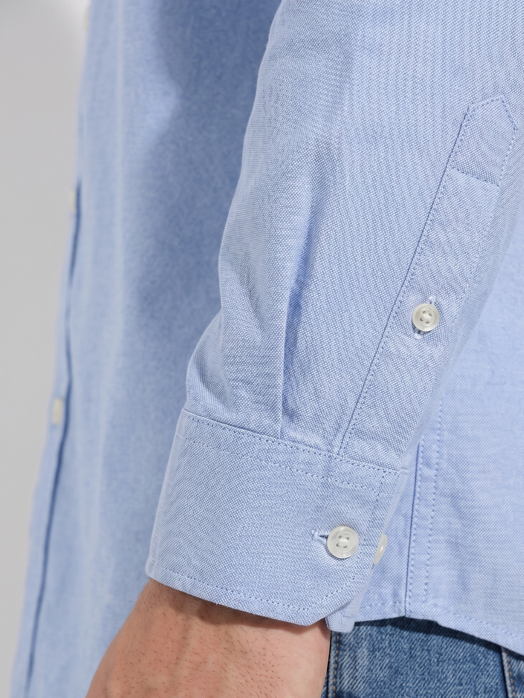 Close up of the tailored cuff and pen pocket detail on Cauzeway chambray blue Oxford shirt sleeve