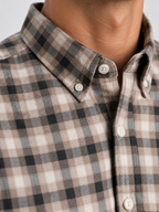 Close up texture of the subtle brown shadow check pattern on premium 100% cotton TFO oxford fabric and structured button down collar by Cauzeway.