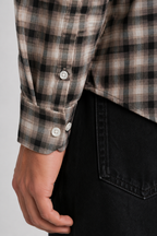 Close up texture of the subtle brown shadow check pattern on premium 100% cotton TFO oxford fabric and Sleeve's angled cuff design by Cauzeway.