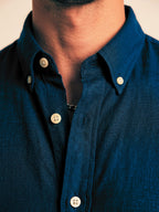 Close up of the button-down collar and Oxford weave texture on Cauzeway Prussian blue shirt