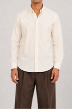 Model wearing Cauzeway off-white cotton shirt with button-down collar, front view