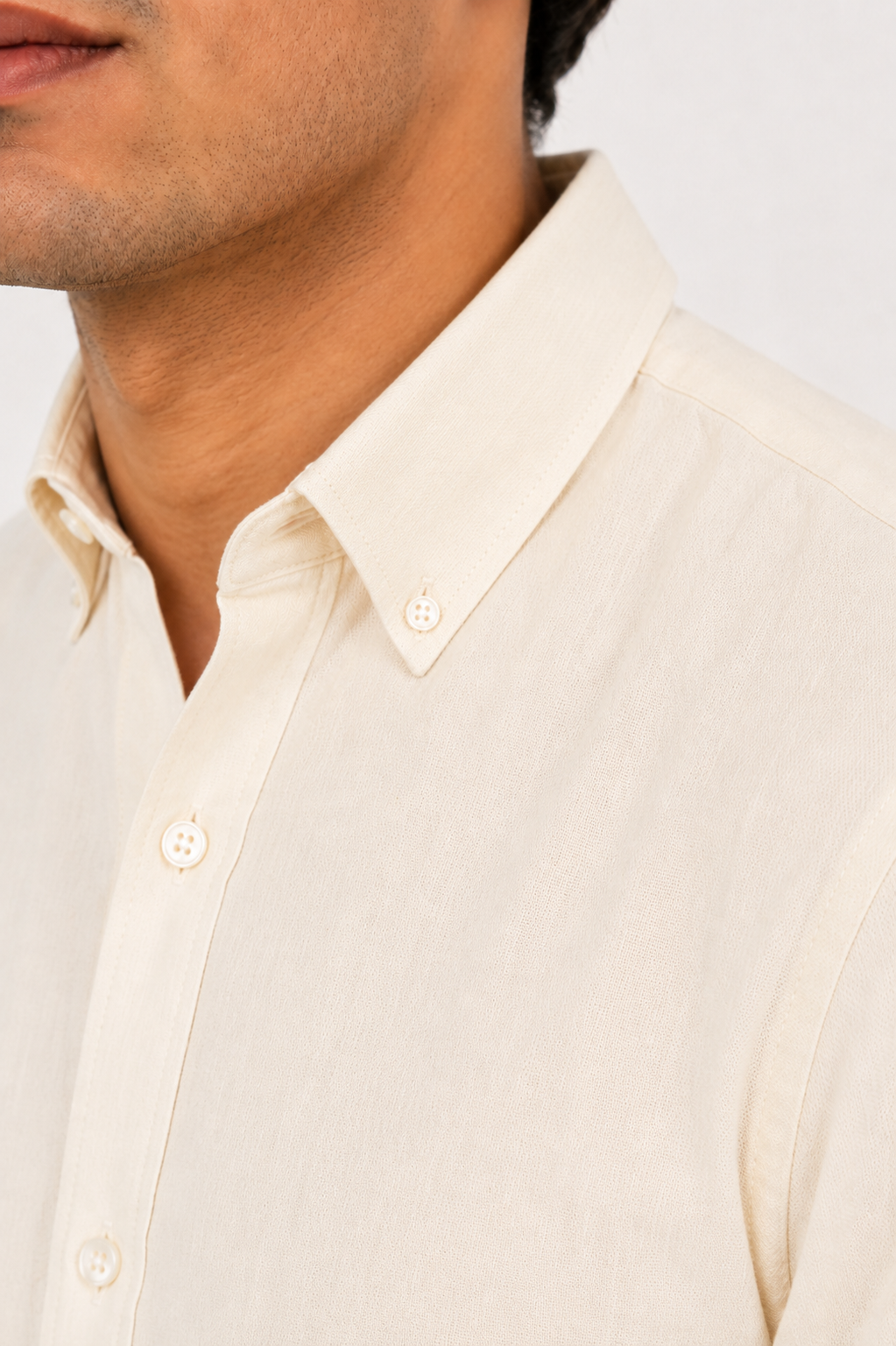 Close up of the button-down collar and soft cotton weave on Cauzeway heritage off-white shirt
