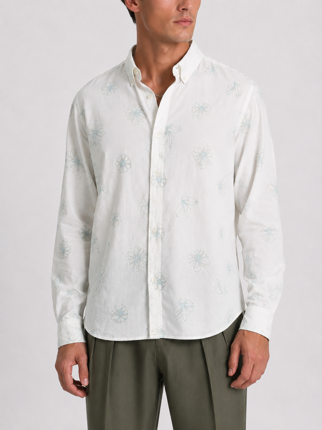Model wearing Cauzeway white floral print shirt with button-down collar, front view.