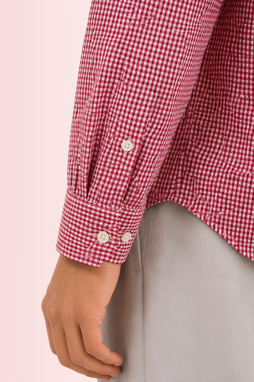 Close up texture of the premium 100% cotton TFO oxford basketweave and adjustable dual button angled cuff on a Cauzeway red check casual shirt.