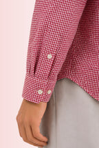 Close up texture of the premium 100% cotton TFO oxford basketweave and adjustable dual button angled cuff on a Cauzeway red check casual shirt.