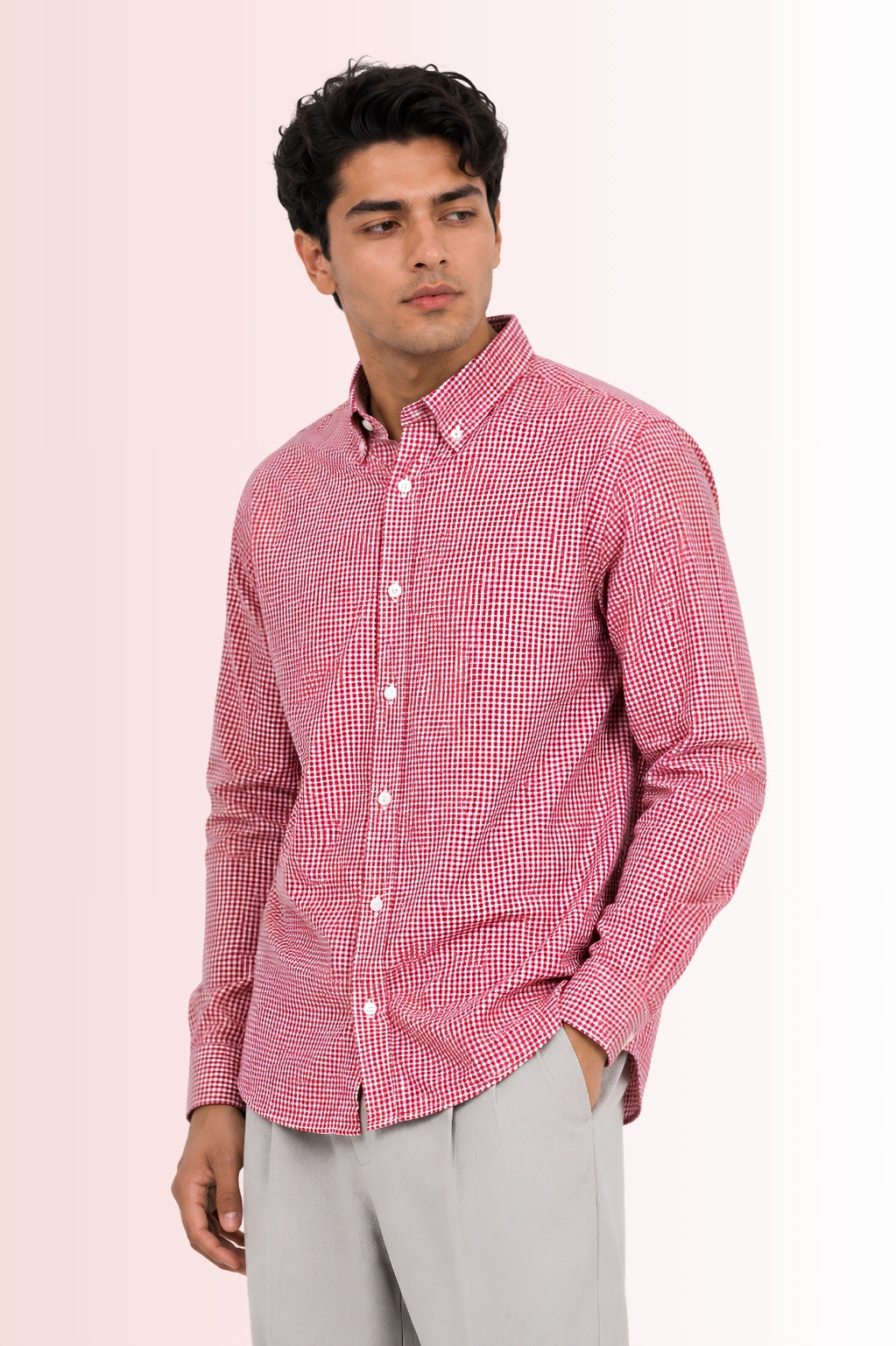 Model showcasing the untucked length of Cauzeway red gingham check shirt engineered for the Indian body type, styled with pleated pant.