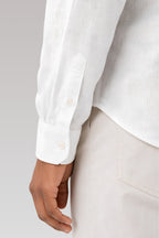 Close up details of the Sleeve cuff design and breathable cotton linen fabric weave on a Cauzeway casual white shirt.