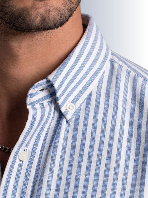 Close up texture of the iconic white and blue university stripe pattern on premium 100% cotton TFO oxford fabric by Cauzeway.