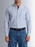 Model showcasing the tucked casual style of Cauzeway blue university stripe shirt engineered for the Indian body type, paired with denim jeans.