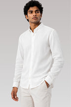 Model wearing Cauzeway white cotton linen shirt, designed for the Indian body type, paired casually with chinos.